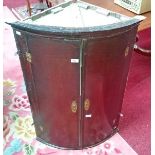 A 19TH CENTURY OAK HANGING CORNER CUPBOARD, 
with moulded cornice over two doors,