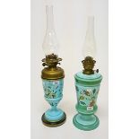 A DECORATED EDWARDIAN TURQUOISE OIL LAMP, 
decorrated with flowers and birds, with brass reservoir,