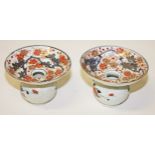 A PAIR OF EARLY CHINESE IMARI SPITOONS, decorated with flowers, each with a handle and a dish top,