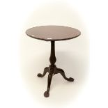 A CIRCULAR MAHOGANY FLIP TOP CENTRE TABLE,