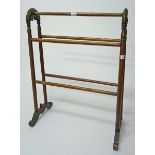 A LATE VICTORIAN WALNUT TOWEL RAIL, with arched ends and five rails, 25in (64cm).