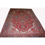 AN ATTRACTIVE PERSIAN HERIZ CARET, 
with floral central medallion,