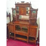 AN EDWARDIAN ROSEWOOD CHIFFONIER, 
profusely inlaid with scrolling foliage, vases and urns,