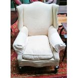 A LIBRARY WING ARMCHAIR, 
early 20th century, with padded back, seat and arm rests,