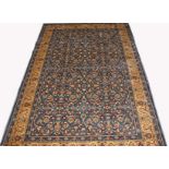 A KASHMIR RUG 
the dark turquoise all over floral field, within a fawn border and smaller bands,