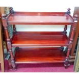 A VICTORIAN THREE TIER MAHOGANY DUMB WAITER, 
with four knop finials on turned supports and legs,