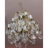 A TEN BRANCH BRASS AND GLASS CHANDELIER, 
with baluster shaped centre, issuing 10 candle arms,