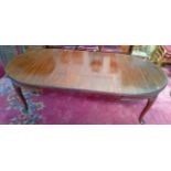 A WALNUT DINING TABLE, 
early 20th century, the moulded top with two spare leaves and D shaped ends,