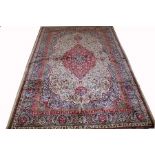 A KASHMIR RUG, 
the ivory floral ground with a centre burgundy medallion,