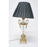 AN ATTRACTIVE CUTGLASS GILT BRASS TWO HANDLED VASE SHAPED TABLE LAMP, 
with dark pleated shade, 34.