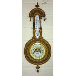 A WALNUT CASED ANEROID WHEEL BAROMETER, 
by Yeats & Son of Dublin, 23in (59cm)h x 8.5in (22cm).