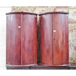 A PAIR OF UNUSUAL GEORGIAN PERIOD MAHOGANY BOW FRONTED HANGING CORNER CUPBOARDS,