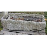 AN ANTIQUE RECTANGULAR CUT LIMESTONE TROUGH, 
44.5in (113cm)h x 18.5in (47cm).