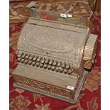 AN OLD HEAVY RELIEF CAST BRASS NATIONAL CASH REGISTER, 
19in (49cm).