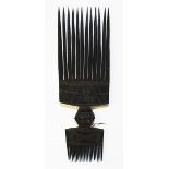 AN UNUSUAL HAND MADE DOUBLE ENDED TRIBAL COMB, 
With geometric designs 9.25in (23cm).