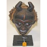 A MASQUERADE MASK, DAN, LIBERIA/IVORY COAST, 
with filed teeth, round eye sockets, horns and bark,