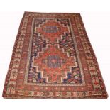 AN ORIENTAL QASHQAI RUG, 
with two stepped iron red cruciform medallion, inside a multi border,