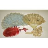 AN UNUSUAL LIGHT BLUE FEATHER FAN, 
with painted wooden sticks,