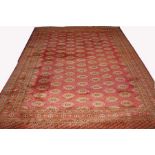 AN ATTRACTIVE BOKARA CARPET, 
the iron red ground with rows of small oval medallions,