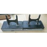 A PAIR OF HEAVY CAST IRON FOOT SCRAPERS, 
each on rectangular Kilkenny limestone block plinth,