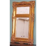 A MODERN GILT WALL MIRROR,