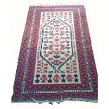 AN AFGHAN RUG, 
the ivory ground with stylised flowers, inside a multiband border,