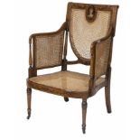 ###WITHDRAWN###AN EDWARDIAN SATIN WOOD BERGERE ARMCHAIR, 
decorated with floral swags, ribbon bows,