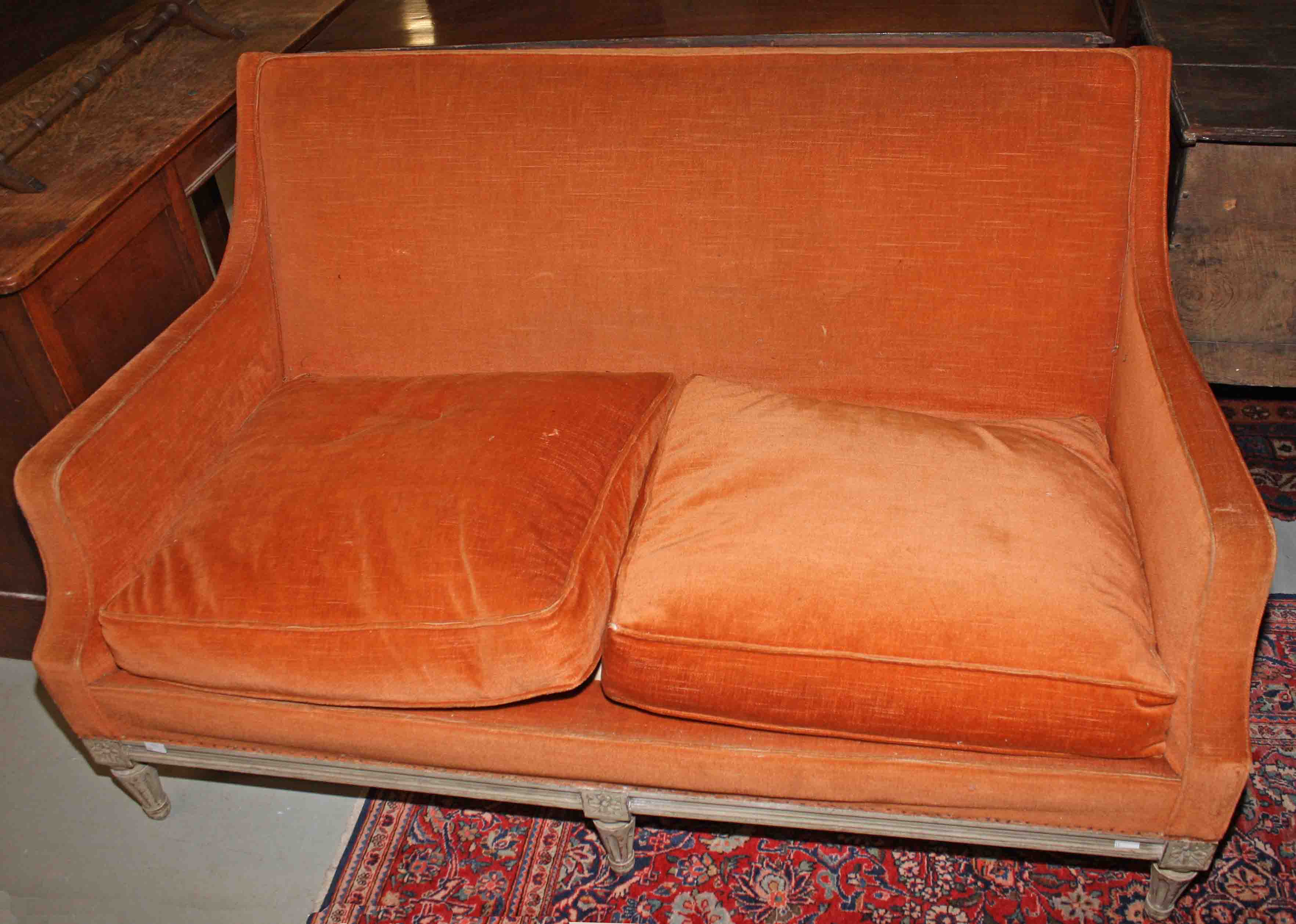 A TWO-SEAT PAINTED FRENCH SETTEE, 
with upholstered back and side panels and a double cushion seat,