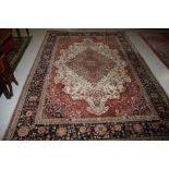 AN ATTRACTIVE HERIZ RUG, 
with central floral medallion, on an ivory ground,