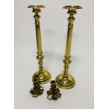 A PAIR OF HEAVY BRASS CANDLESTICKS, 
each with reeded stem, on circular base, 22.