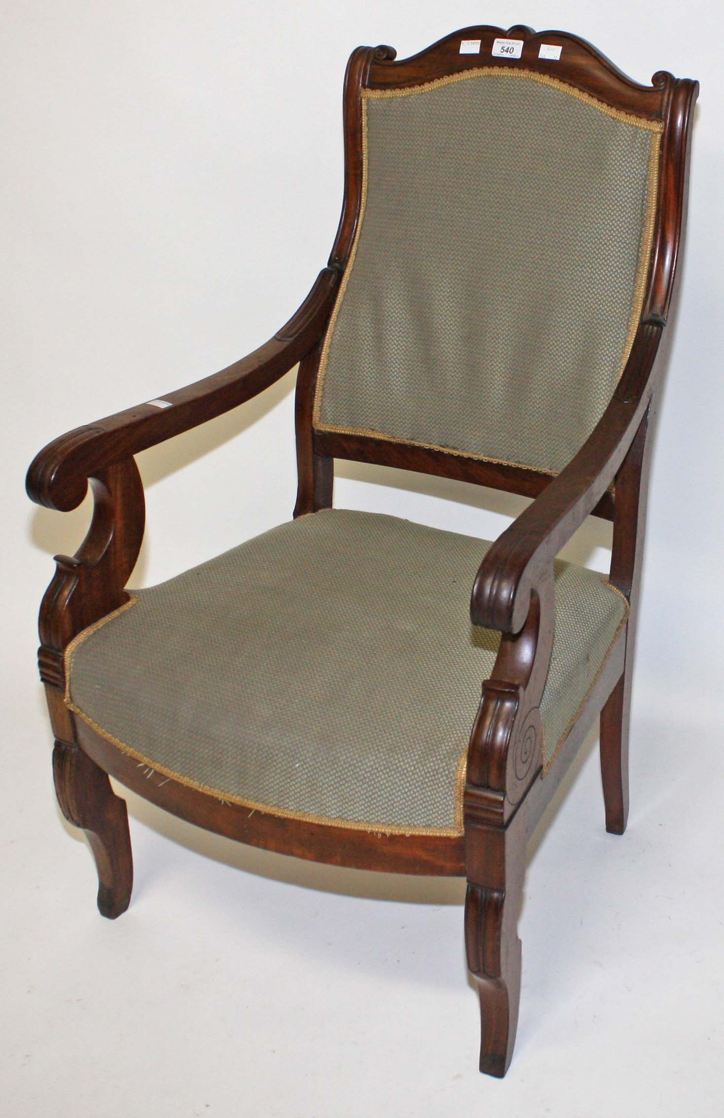 A CHARLES X MAHOGANY ARMCHAIR, 
with shaped top rail above a padded back and bow fronted seat,