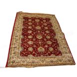 AN ATTRACTIVE KASHMIR RUG, 
with burgundy floral field and ivory border,