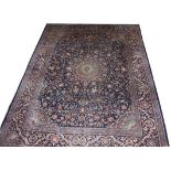 A GOOD QUALITY ORIENTAL TABRIZ CARPET, 
with centre circular medallion, on a dark blue ground,