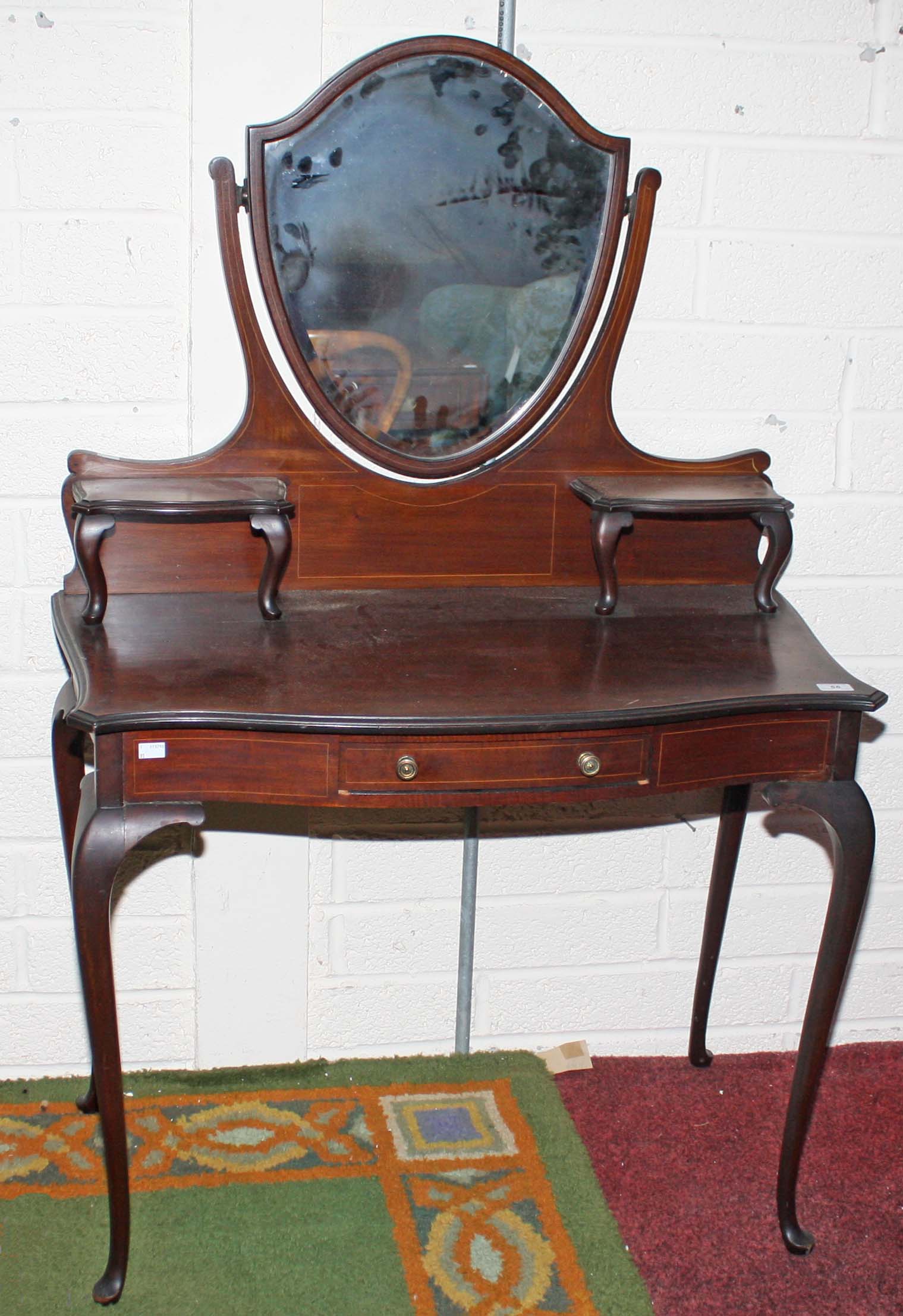 AN EDWARDIAN SERPENTINE SHAPED INLAID MAHOGANY DRESSING TABLE,