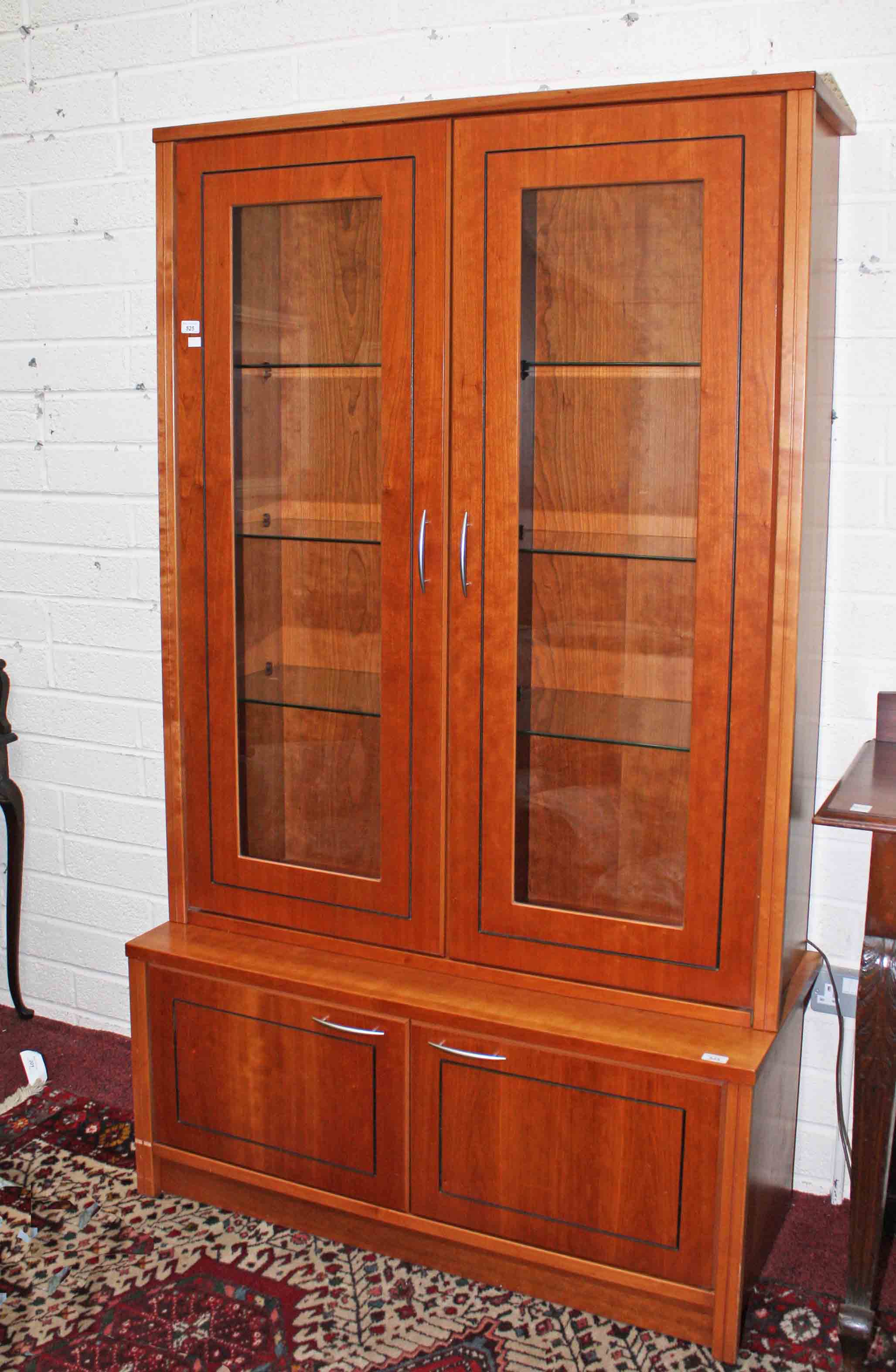 A MODERN TEAK DISPLAY CABINET, 
with two glazed upper doors,