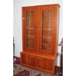 A MODERN TEAK DISPLAY CABINET, 
with two glazed upper doors,