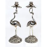 A VERY IMPRESSIVE PAIR OF SILVER PLATED CANDLE STICKS, 
each in the form of a crane,