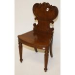 A WILLIAM IV PERIOD MAHOGANY HALL CHAIR, 
with leaf carved shield shaped back,