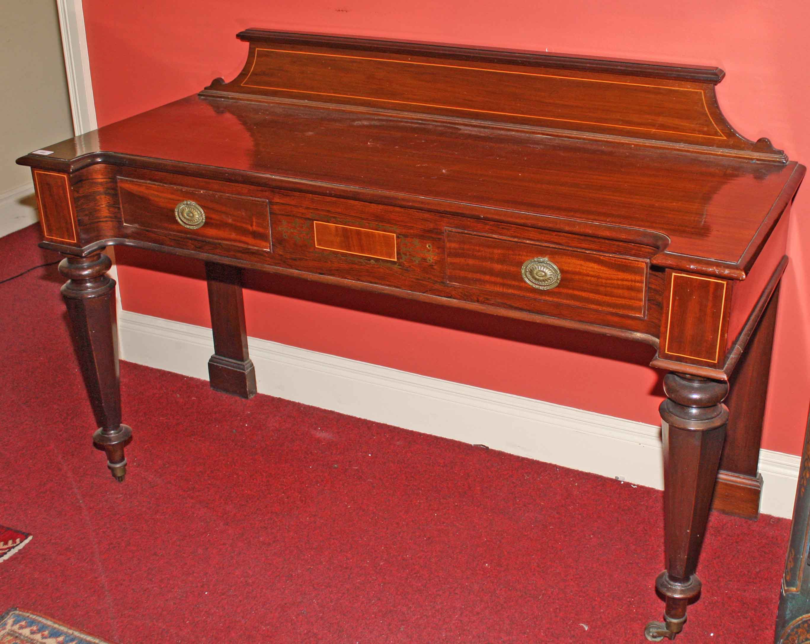 A BRASS INLAID ROSEWOOD AND MAHOGANY SIDE TABLE, 
with shaped back above an inverted breakfront top,