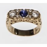 A THREE STONE SAPPHIRE RING, 
the centre sapphire flanked with two white stones,