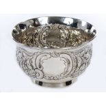 AN IRISH GEORGE II EARLY GEORGE III SILVER CRESTED BOWL, 
chased with flowers,