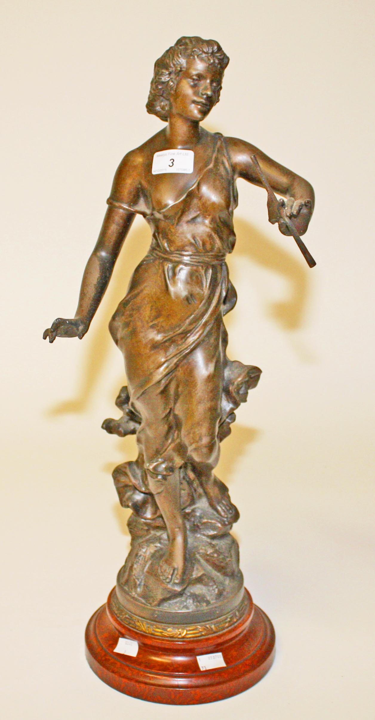 A BRONZED SPELTRE FIGURE, 
modelled as Classical woman, on circular faux marble base, 25in (64cm).