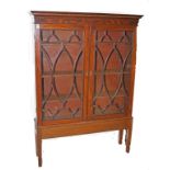 A GEORGE IV PERIOD MAHOGANY BOOKCASE, 
with dentil inlay and moulded cornice,