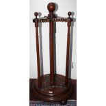 A VICTORIAN MAHOGANY CUE STAND, 
with turned centre stem and ball finials,