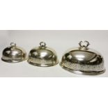 A SET OF THREE 19TH CENTURY SILVER PLATED GRADUATING MEAT DISH COVERS, 
of ogee form,