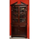 A 19TH CENTURY MAHOGANY CORNER CABINET, 
with Greek key moulded divided pediment,