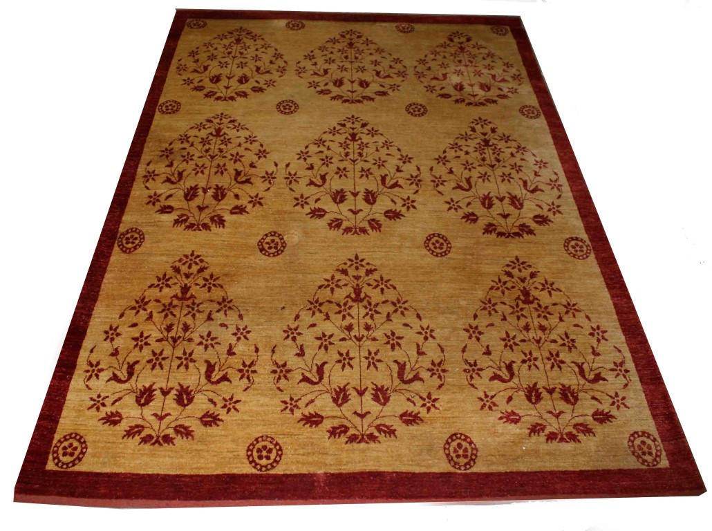 AN INDIAN DARK CREAM GROUND CARPET, 
with stylized red flowers, inside a red border,