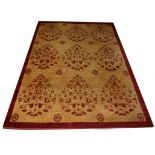 AN INDIAN DARK CREAM GROUND CARPET, 
with stylized red flowers, inside a red border,