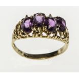 AN UNUSUAL AMETHYST FOUR STONE RING, 
set in 14K yellow gold band.