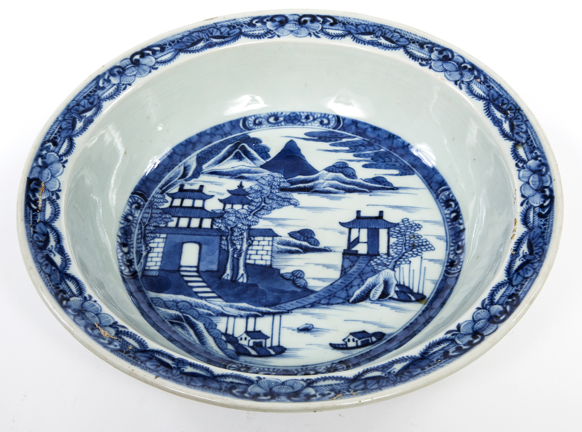 A CHINESE BLUE AND WHITE BASIN BOWL, 
18th century, decorated with dwellings in a landscape,